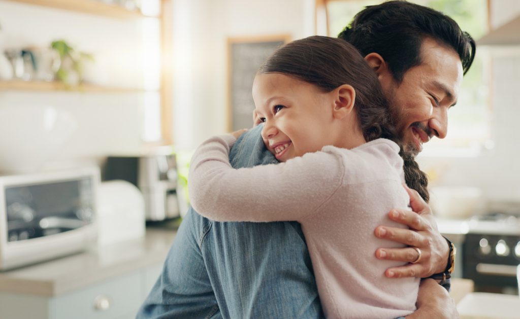 father hugging daughter